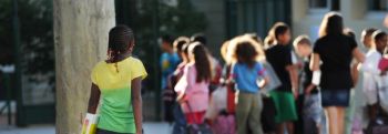 A pupil arrives in the courtyard of the Abbe de l'Epee elementary school on September 3, 2013 in Marseille, southern France, prior to enter her classroom on the first day of school. More than 12 million pupils went back to school today in France