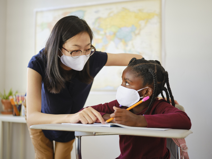 An Elementary School Student and Teacher in a Classroom