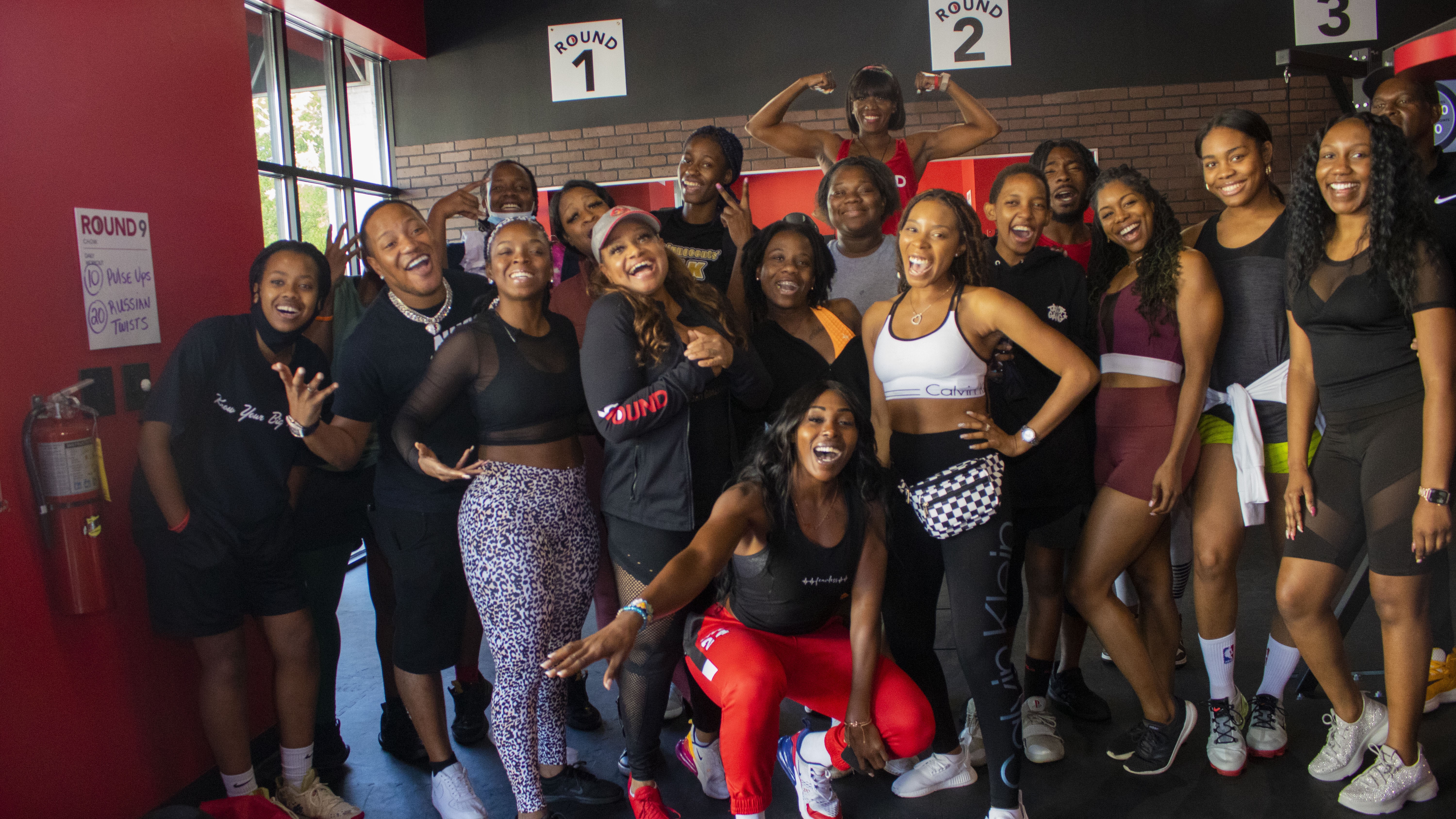 A group photo of the 9round owner, Geri Gonsalves, Pro Basketball player Jemimah Ashby, K.Samone posing with all the attendee's of the event