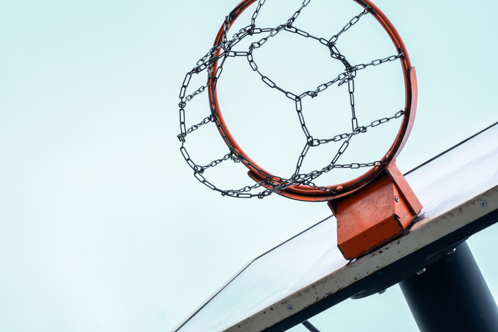 Basketball Hoop With Metal Chain Net Against Clear Sky.